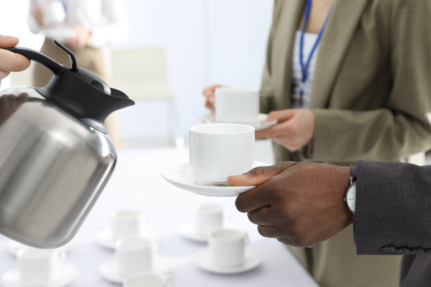 女招待在咖啡休息时间倒热饮，特写图片下载