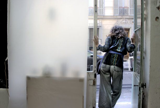 一个女人站在她工作室门口图片下载