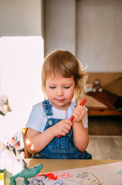 小孩子在家里的儿童桌上用毡头笔画画。图片下载