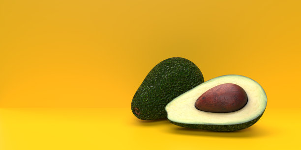 牛油果半切，黄色底色图片下载