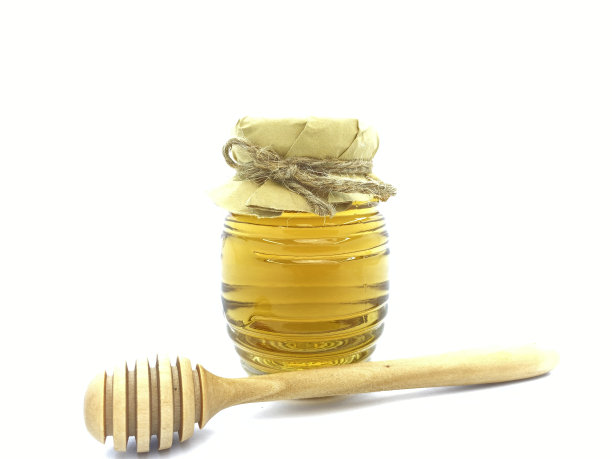 复古独特的蜜蜂瓶玻璃和木勺包装设计理念。健康益处，海藻糖，有机酸，酶，葡萄糖酸，甲酸图片下载