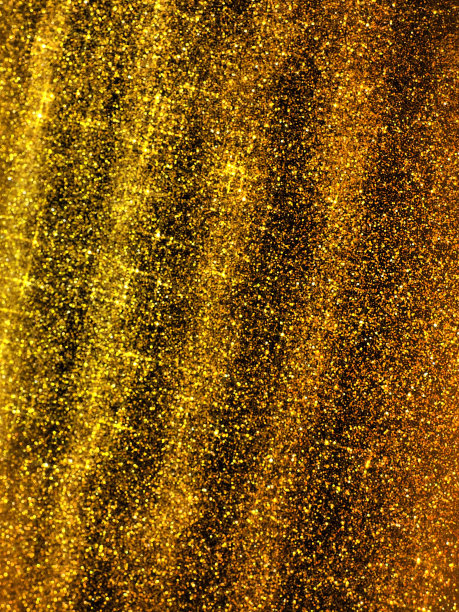 金色的波光闪烁。金色闪光纹理背景。闪闪发光的包装纸与亮片和闪闪发光。节日的金色散景和闪光。斜条纹和波浪图片下载