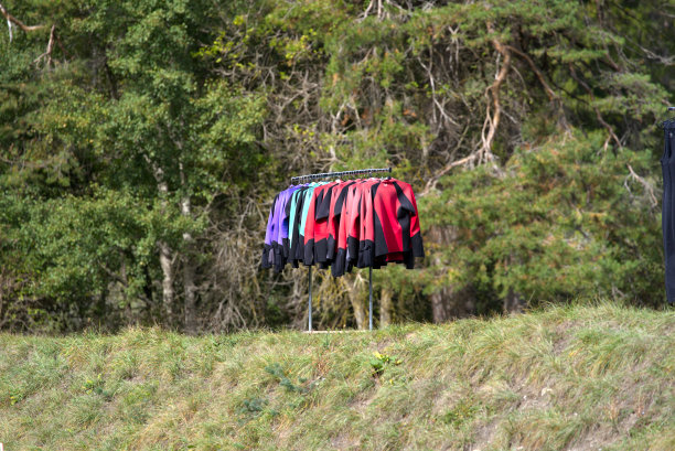 在一个美丽的日子里，在瑞士Versam山村的秋日阳光下，晾在架子上的氯丁橡胶皮划艇衣服。图片下载