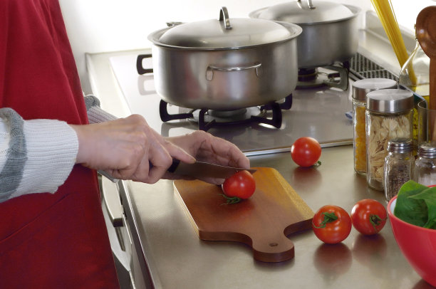 与穿红围裙的女人一起做饭的图片图片下载