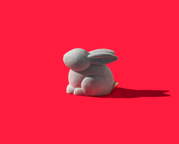 2023年中国新年的概念。红色背景上的兔子。极简的兔年构图。图片下载