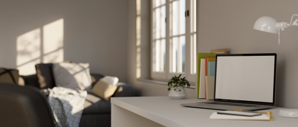 笔记本电脑模型在白色电脑桌在最小的当代公寓客厅图片下载