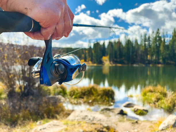 男性渔民在落基山湖旋转铸造钓鱼照片系列图片下载