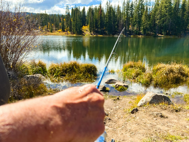 男性渔民在落基山湖旋转铸造钓鱼照片系列图片下载