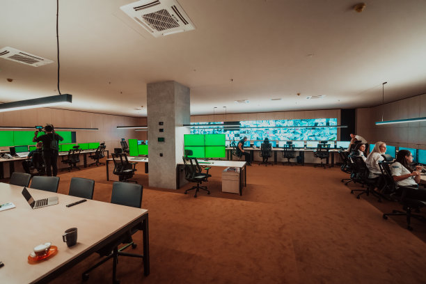 专业摄像师与gimball视频单反录制视频安全数据中心操作员，同时在闭路电视监控室工作，查看多个监视器系统Con团队工作图片下载