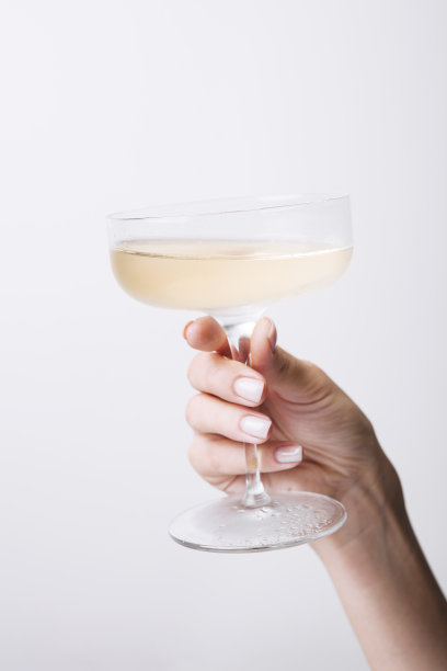 手持盛有香槟的酒杯图片下载