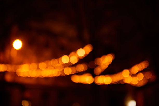 橙色，黄色，黑色背景散焦。圣诞节的街头装饰。节日的花环。图片下载