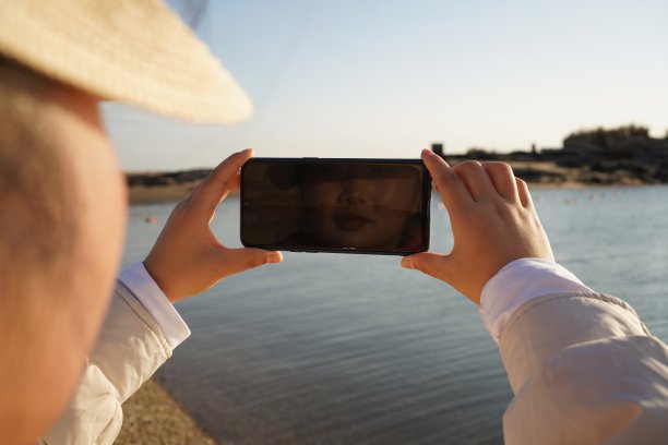 男人在海边用智能手机图片下载