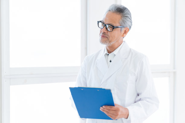 穿白大褂的老年医生，面谈单图片下载