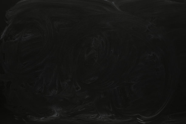 粉笔擦在黑色黑板作为背景，特写。文本空间图片下载