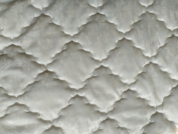 背景纹理:白色床单图案，床垫，特写。图片下载