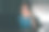 一个年轻的青少年学习和工作，在家里的桌子上使用笔记本电脑，微笑着做作业。屏幕的光线照在脸上。图片下载