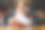 近距离低角度观看漂亮的金发女性使用手机，打字在线信息坐在餐桌上一杯红酒在餐厅。图片下载