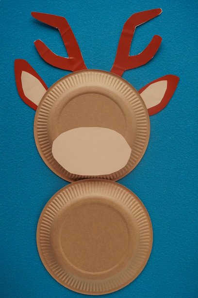 圣诞新年圣诞老人的鹿手工制作。一步一步的照片指导。DIY的概念。6-13步。剪一个肉色的椭圆形，把鹿的脸粘在一起。俯视图，平面布局图片下载