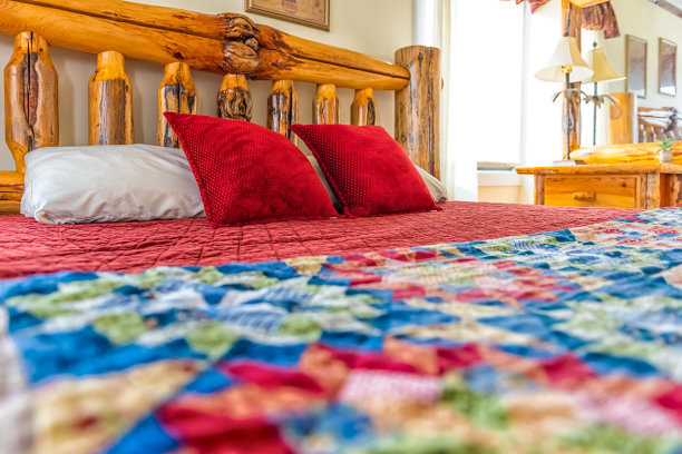 复古复古的卧室，卧室里有床，房间里有老式的装饰，木框架床头板，明亮的自然光从小屋小屋的窗户射进来图片下载