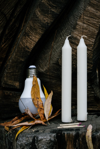 木制背景上有蜡烛和灯泡。图片下载