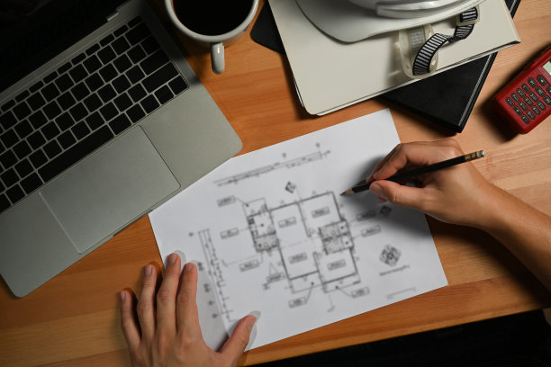 建筑师在木桌上用笔记本电脑做建筑计划。图片下载