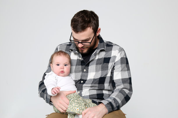父亲慈爱地抱着他的女儿在白色的背景图片下载