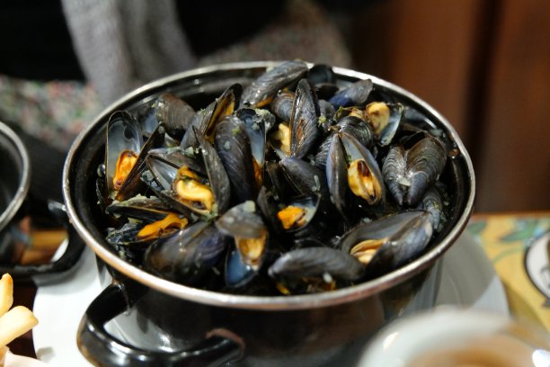 蓝色贻贝装在黑锅里图片下载