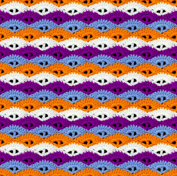 对比无缝针织纹理。贝壳形状的图案是用多色线钩针编织而成的。图片下载