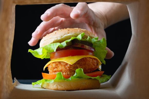 鸡肉汉堡纸袋包装。早餐吃快餐。垃圾食品或不健康食品的概念图片下载