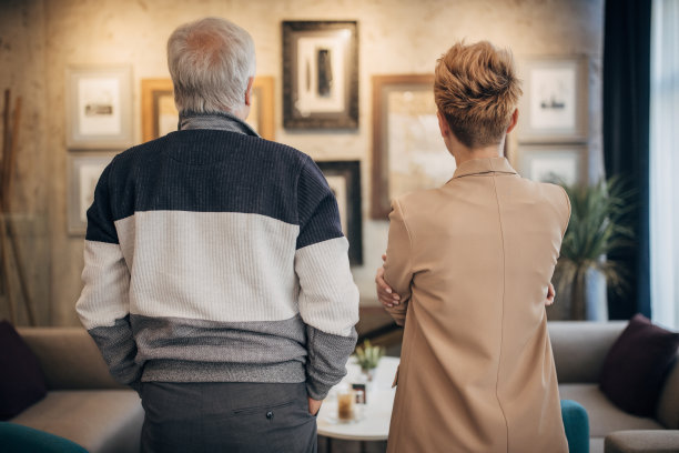 父女俩边看画边谈生意图片下载
