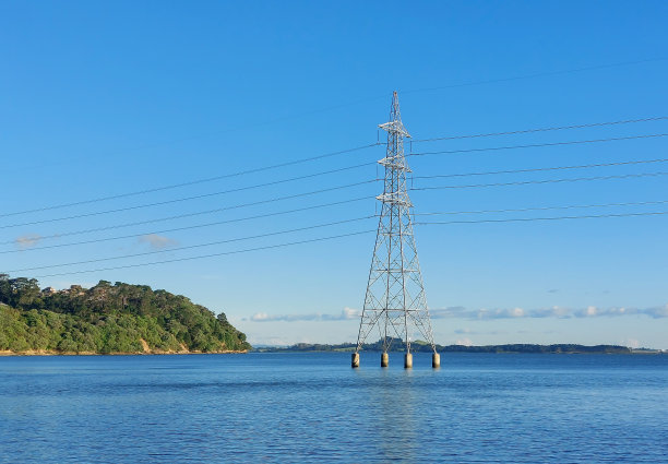 新西兰，布洛克豪斯湾，蓝天海洋中的电力塔图片下载