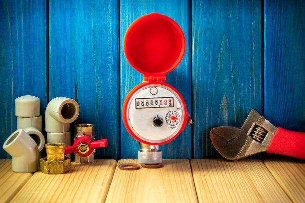 新的水表配件在蓝色木制背景。图片下载