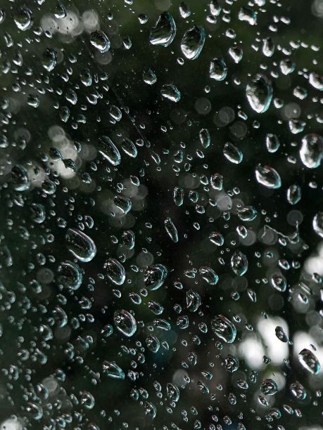 一套逼真的彩色肥皂泡创建一个设计。透明现实的肥皂泡孤立在黑暗的背景。图片下载