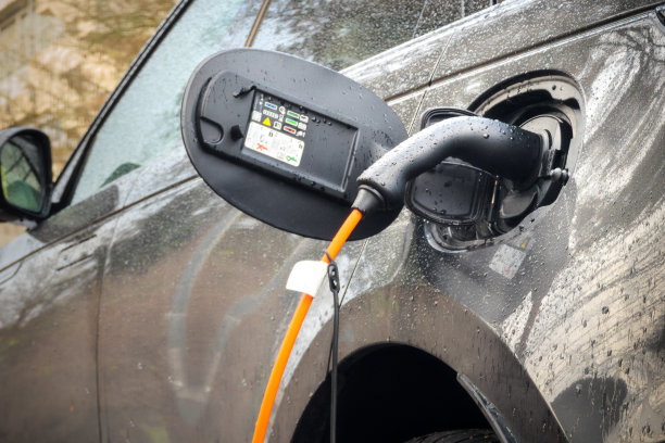 下雨时给电动汽车充电图片下载