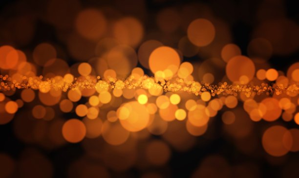 金色暗抽象闪光背景与散焦散光圣诞在黄色，金色，橙色，黑色图片下载