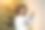 一名非裔美国妇女在房子舒适的客厅的圣诞树旁拿着一份节日礼物图片下载