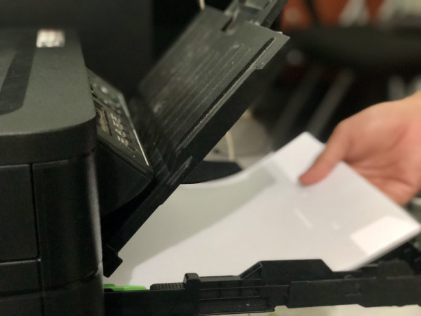 一个工人正在把白纸装进打印机图片下载