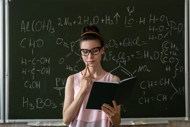 化学老师对着黑板讲解化学公式图片下载