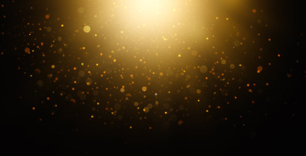 抽象的黑色背景与金色斑点，闪光的光图片下载
