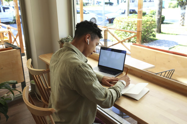 年轻人在咖啡店远程工作。图片下载
