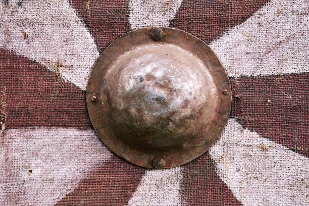 带有白色螺旋条纹的红色古董盾牌，中世纪战士。欧洲中世纪事件的重建图片下载