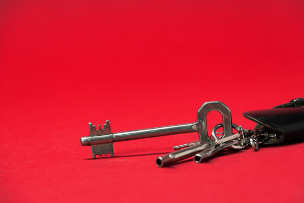 黑色皮革钥匙持有人与钥匙在红色背景。图片下载