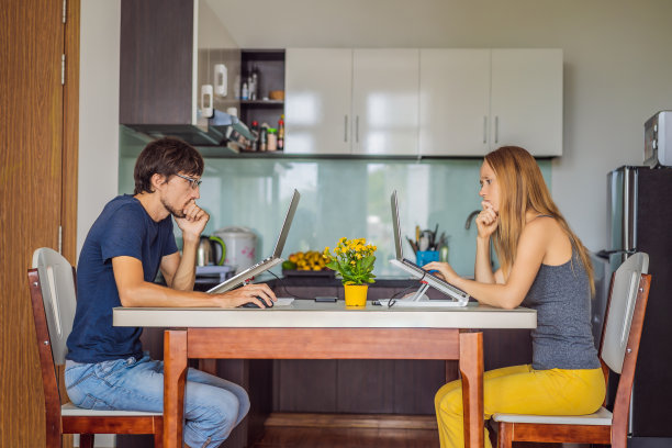 在COVID - 19隔离期间，在厨房工作的男人和女人图片下载