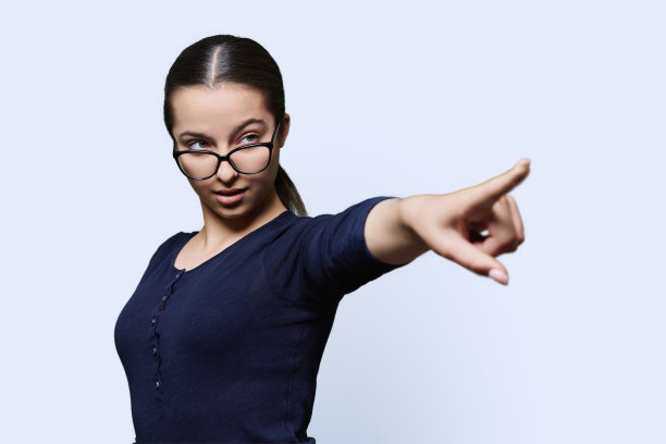 严肃的十几岁女孩学生用手指指着空白的文字图片下载