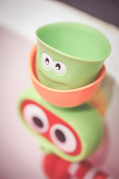 在一个模糊的背景上，一个小的绿色青蛙的垂直镜头图片下载