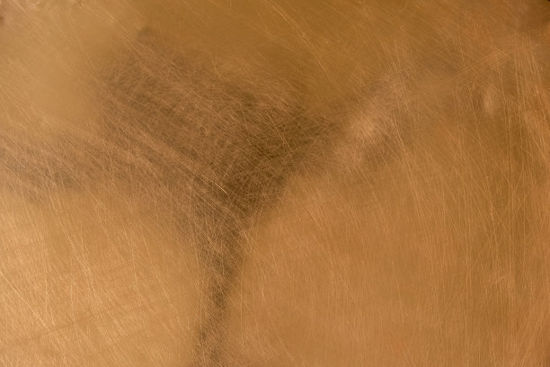 铜的背景。铜表面有划痕。中间有阴影。图片下载