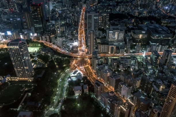 长时间曝光的灯光在东京星形道路环，与夜间的城市景观，空中图片下载