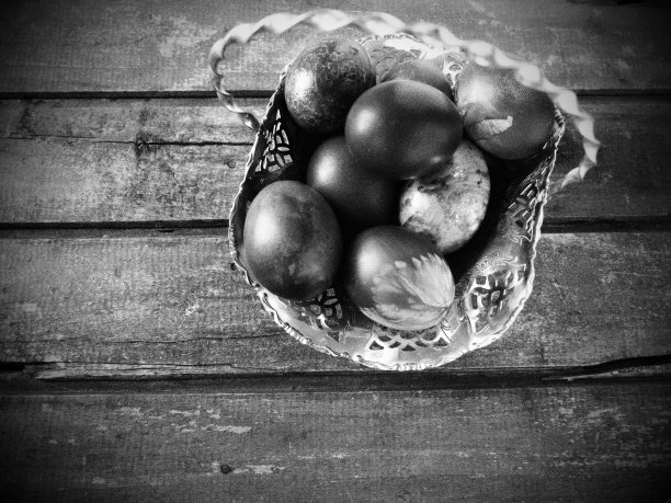 木桌上的一个旧金属糖果碗里装着复活节彩蛋。复活节，基督的复活，基督的光明复活，最古老的基督教节日。黑白照片图片下载