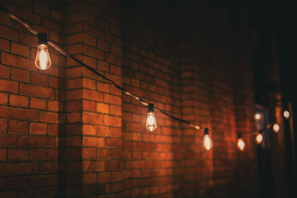 砖墙背景上的灯泡图片下载