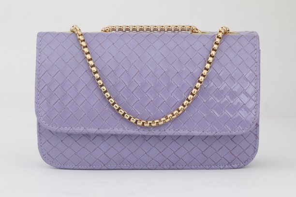 特写镜头是一个时尚的紫色包，金色的链子孤立在白色背景上图片下载